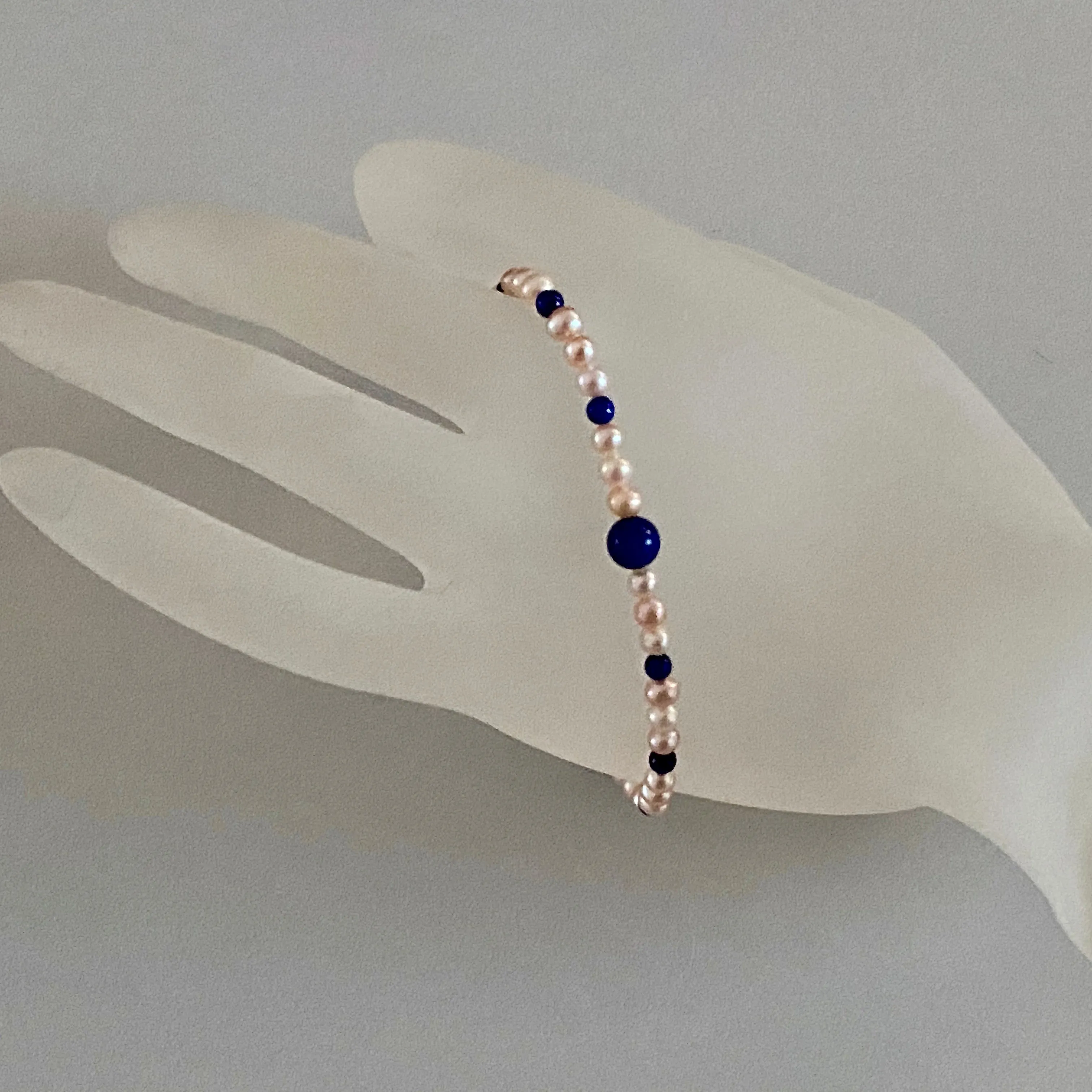 Arpaia 7.25" Stretch Bracelet with Natural Lapis Lazuli Beads, Natural Blush Pink Color Cultured Freshwater Pearls, and Handmade Sterling Silver Bali-Style Bead