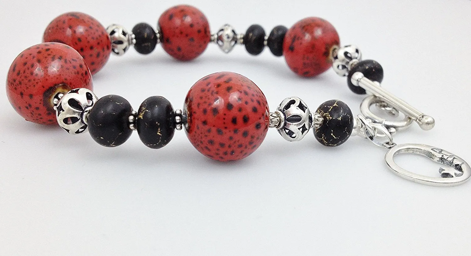 Sterling Silver, Red/ Black Raku Porcelain and Bronze Infused Black Turquoise Bracelet